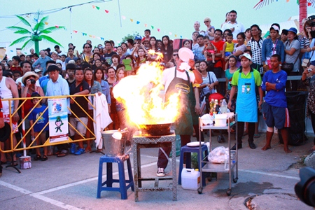A chef prepares pak boon fai dang - aka flying morning glory - a popular item on Pattaya menus both for its taste and the theater created by chefs preparing it.