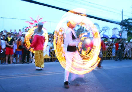  Fire twirlers thrill the audience.