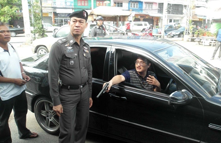 Watcharawong Leelasirinwong shows police and the media how he shot up a food vendor for a chili sauce incident.