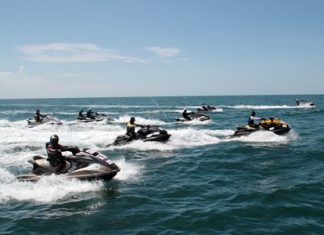 A fleet of 40 jet skis make their way across the Gulf of Thailand to commemorate the crossing 47 years ago by HM the King in a sailboat he himself made.