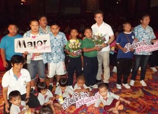 Thanakorn Pulilaekin (center, white shirt), film administrator for Major Cineplex Group, unveiled the Major Care Foundation initiative May 23 at The Avenue galleria theater.