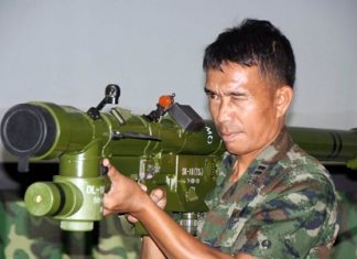 A Royal Thai naval officer demonstrates how to hold the new weapon when preparing to fire.