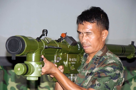 A Royal Thai naval officer demonstrates how to hold the new weapon when preparing to fire.