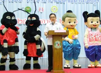 Dr. Pornthep Siriwanarangsun, with help from a quartet of mascots, teaches students at Assumption School how to avoid getting dengue fever and how to get rid of mosquitoes.