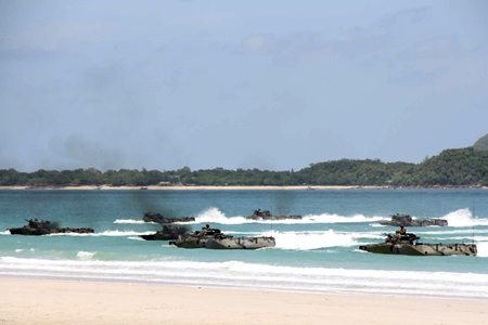 Combined forces storm the beaches in Sattahip in amphibious vehicles during the 2013 CARAT military exercises.
