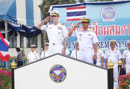 Rear Adm. William C. McQuilkin (left), commander of U.S. Naval Forces Korea, and Rear Adm. Paithoon Prasopsin (right), commander of the Royal Thai Navy’s Frigate Squadron 2, salute the troops during the opening ceremonies for CARAT 2013.