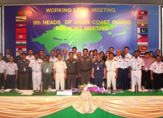 Delegates pose for a group photo during this summit of Coast Guard agencies from 19 countries.