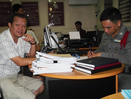 Cable company manager Dechthana Boonyaprapachote files an official complaint with police.