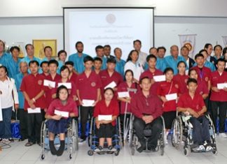 Mayor Itthiphol Kunplome and Rotarians pose for a commemorative photo with the Redemptorist Vocational School students who received scholarships.