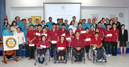Mayor Itthiphol Kunplome and Rotarians pose for a commemorative photo with the Redemptorist Vocational School students who received scholarships.