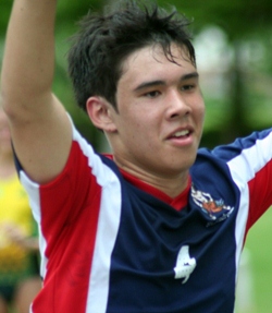 Johnny raises his arms in triumph.