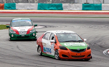 Andrey Snetkov (right) steers his TWPro Racing - TEZ Tour Thailand Toyota Vios during Race 1 of the Thailand Super Series Championship at the Sepang racetrack in Malaysia, Saturday, May 25.