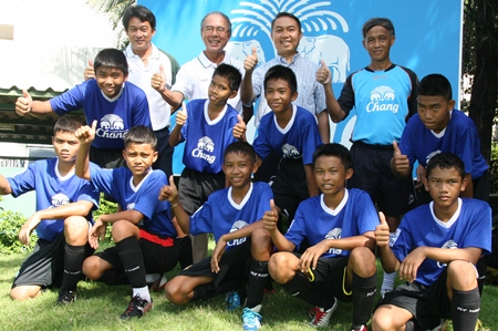 The boys from the Father Ray Children’s Home and Father Peter (second right) pose with officials from the Chang-Everton Football Academy.