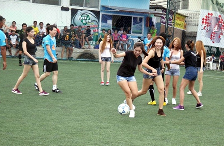 Models take on VIPs in the match of the day.