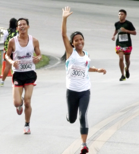 Sunthorn Duanthiang, from the Pattaya Team Club, gestures to spectators on her way to winning first place in the women’s event.