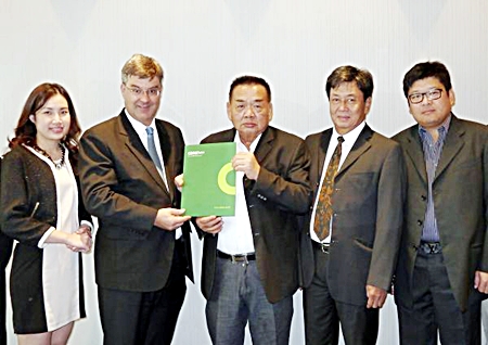 Boonmee Sukprapruti (center), Chairman of RNC (Thailand) Co., Ltd., and Sorayouth Prompoj (2nd from right), the former Ambassador for Thailand, exchange agreements with James Pitchon (2nd from left), Executive Director, and Jariya Thumtrongkitkul (left), Senior Retail Manager of CBRE Thailand.
