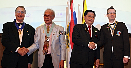 DG Thatree Leetheeraprasert congratulates outgoing president Carl Dyson as DG Suwan Sanpaporn installs Nigel Quennel as the new president of the Rotary Club Eastern Seaboard.