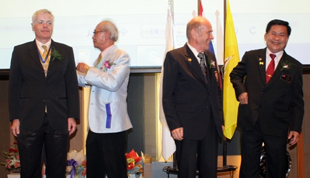 Outgoing president Heiner Moessing and incoming president Dr Otmar Deter of the Rotary Club Phoenix Pattaya participate in the installation rituals.
