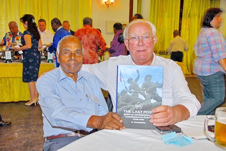 Mr S.K. Phillips receives a ‘Signed Book’ from Dato’ R. Thambipillay DPMP, MBE. AM at Troops Night.