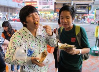 This tastes good! A Year 9 student samples some Hong Kong food.