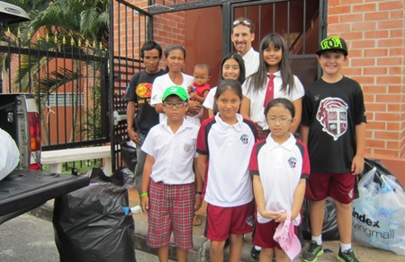 Nat and his students help us load up the recyclables with Mr. Rung, his wife Tukada and son Lar in the back left.