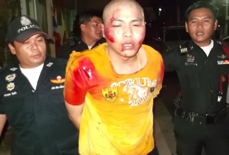 Police bring in Kritpol Khruthern for shooting a motorcyclist during a road rage crime that spilled over into a Pattaya neighborhood.