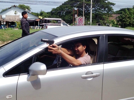 Niran Limchoey shows police how he allegedly shot and killed one of his rivals.
