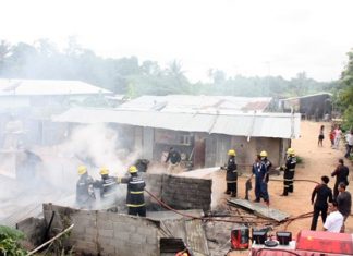 It took firefighters about 30 minutes to extinguish the fire that swept through two houses at a Sattahip construction camp.