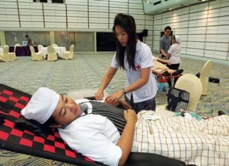 A nurse extracts blood from one of many Asia Hotel employees who took the time to donate earlier this month.