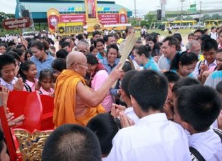 A highly revered monk works his way through the congregation, sprinkling them with holy water as they swear to stay away from narcotics.