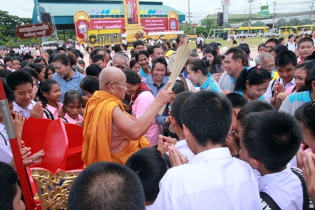 A highly revered monk works his way through the congregation, sprinkling them with holy water as they swear to stay away from narcotics.