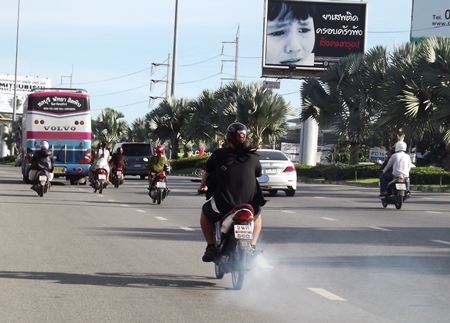 One of the thousands of motorcycles in Pattaya belching out an excess of exhaust smoke.