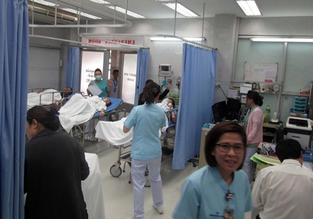 Medical staff at Pattaya Memorial Hospital tend to the ill patients from Chiang Mai.