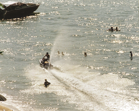 1995 - Safe to swim in Pattaya? Swimmers play in shallow water amongst speed boats and speeding water scooters - in the area where a swimmer was struck and killed.