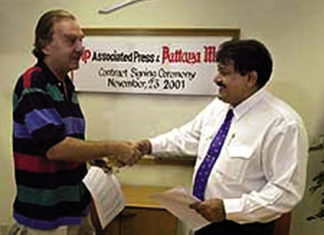 Denis D. Gray, Chief of Bureau, Associated Press, Bangkok (left) and Pattaya Mail Managing Director Peter Malhotra sign an agreement, making Pattaya Mail the first newspaper in Thailand outside of Bangkok to join the AP family.