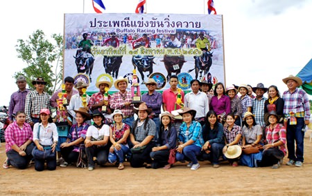 The owners of winning buffaloes pose for a group picture during the closing ceremony.
