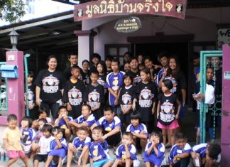 Baan Jing Jai wearing their W.A. football shirts.