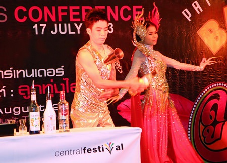 Woodlands Hotel & Resort’s bartender shows off his skills, accompanied by the hotel’s Miss Bartender, during the press conference announcing this year’s Pattaya Bartender Competition Aug. 28.