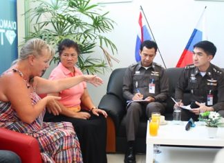Pol. Col. Suwan Chiewnawinthawat (right) and Pol. Lt. Col. Anek Srathongyuu listen to complaints from Russians at the Russian Convenience Center in Jomtien.