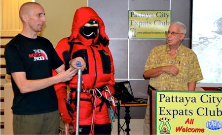 With the aid of a manikin, David demonstrates the clothing and gear necessary to climb Everest, including the ice pick. MC Richard Silverberg looks on.