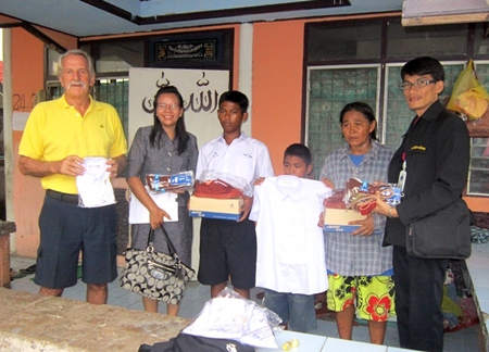 Youngsters receive their school uniforms.