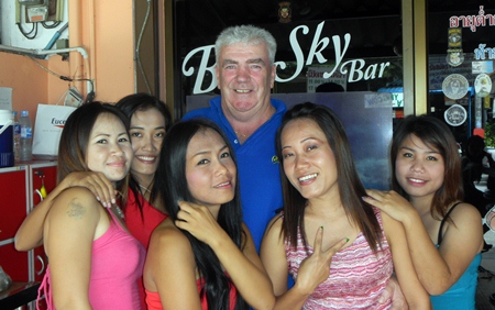Russell Benson celebrates his win with the staff at Blue Sky Bar.