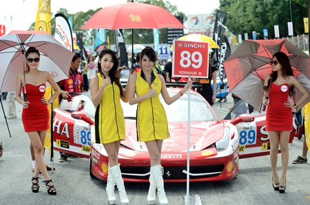 Cars and brollies line up on the starting grid.
