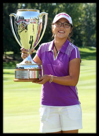 Lydia Ko of New Zealand poses with the champion’s trophy after winning the LPGA Canadian Women's Open golf tournament in Edmonton, Alberta, Sunday, Aug. 25, 2013. 