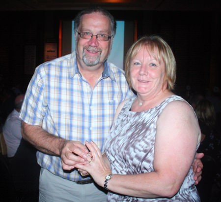 David Gordon presenting his wife with the 14 karat diamond ring he won for their pearl (30th) wedding anniversary.