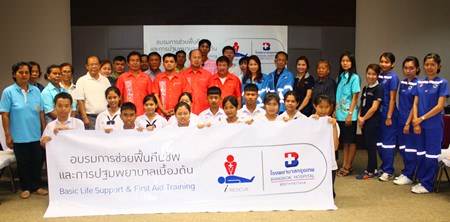 Trainers and trainees gather for a group photo after the event.