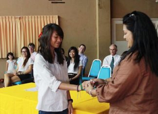 Humanities Prefect Trisha gets a special white GIS wristband from her mother.