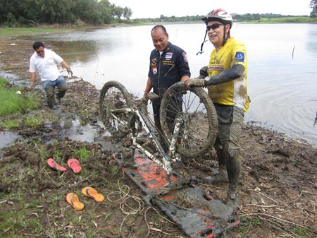 Wolf Minderjahn thanks rescue workers for pulling him and his bike out of the mud where they had been stuck for 3 hours.