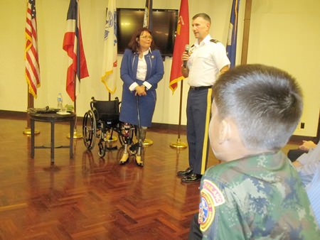 Young Marines L/Cpl Bret Mays watches as Col Desmon Walton introduces Congresswoman Tammy Duckworth at JUSMAGTHAI.