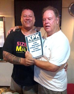 The boss presents the KPK voucher to Mike Johns.